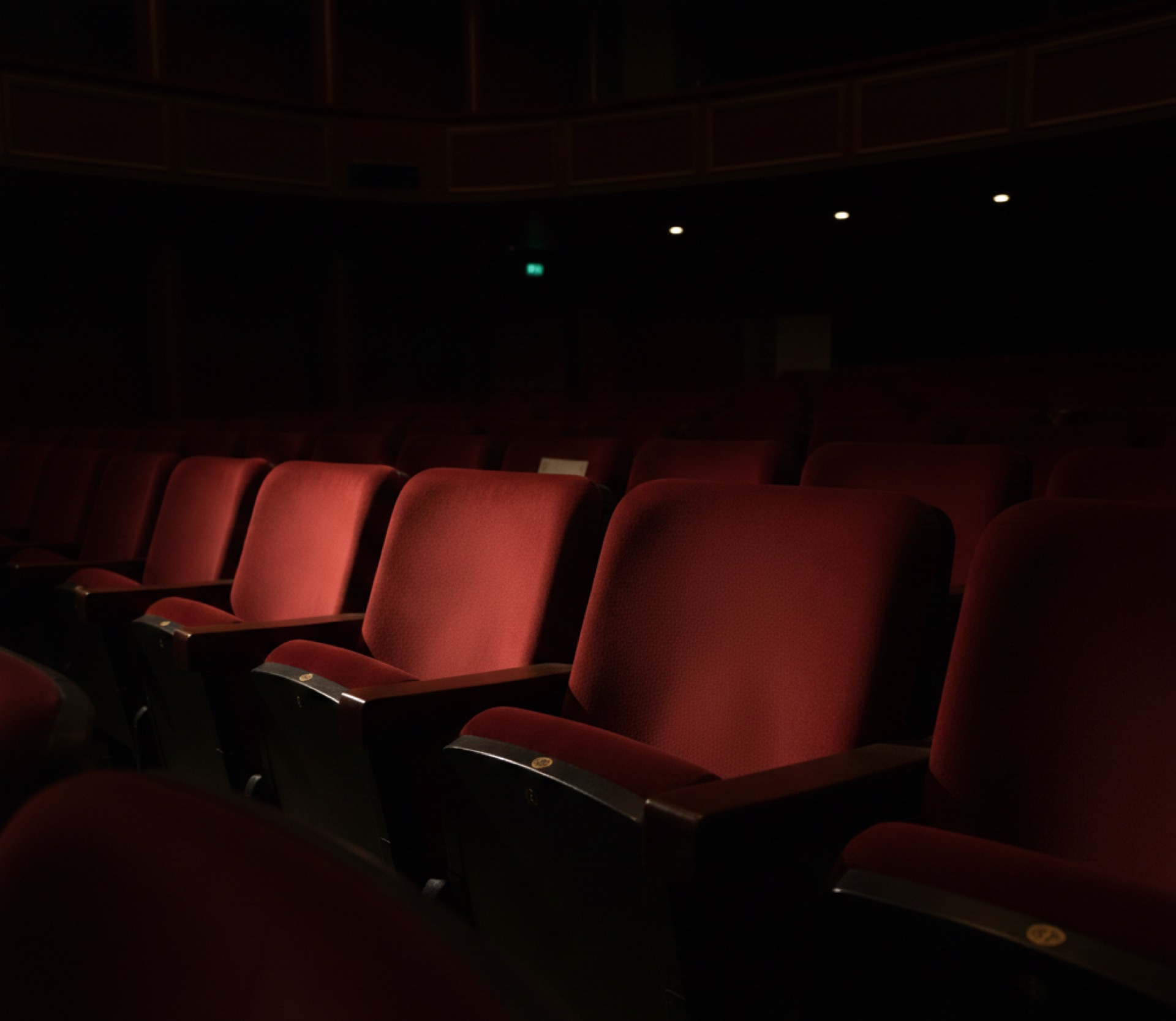 Deep red theatre seating in low light